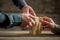 Hands building a tower of wood blocks