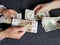 hands of business man and woman exchanging russian banknotes and american dollars bills