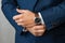Hands of a businessman, close-up, buttons on a watch