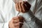 Hands of a businessman, closeup, button sleeves on a shirt