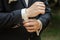 Hands of a businessman, closeup, button sleeves on a shirt