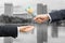 Hands of businessman passing Australian dollar banknote.