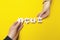 Hands of businessmen folded the word `IDEA` from puzzles on yellow background. Creative strategy and business solution. Brainsto