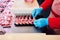 Hands of a butcher packaging raw lamb ribs in a butcher shop