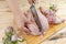 Hands butchering the chicken. Hands of a woman with a knife