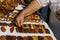 hands of a buyer choosing a wooden comb