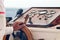 Hands of the captain holding the wheel on the deck of the ship