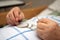 Hands of a care-dependent person holding glasses