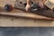 Hands carpenter working a wooden rustic old board with a milling