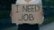 Hands of the caucasian businesswoman holding poster cardboard with need job jobless message. Jobless female manager