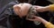 Hands of caucasian female hairdresser washing hair of relaxed female customer at hair salon