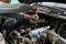 hands of caucasian mechanic unscrewing diesel engine parts of modern SUV