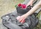 The hands of a caucasian woman take a mobile phone lying on a biker leather jacket