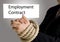 Hands in chain with employment contract banner