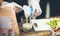 Hands chef at kitchen putting dried yogurt into glass