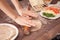 Hands chef rolling pastry for tacos