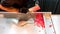 Hands of chefs cutting colorful sugar into small pieces.