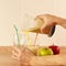 Hands chefs poured fruit cocktail in glasses