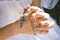 Hands of child holding rosary beads and cross