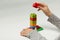 Hands of the child lay a pyramid of colorful cubes on white background