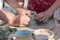 Hands of a child learning pottery