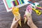 In the hands of a child Paper Fan paper ice cream on a wooden table. Childrens art summer project, handmade, crafts for children.