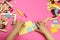 Hands of a child playing with colored blocks, bricks on a pink background