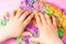 Hands of a child playing with multicolored kinetic sand