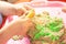 Hands of a child playing with multicolored kinetic sand