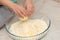 Hands of a child squeezing a lemon on the ingredients of a cake