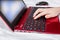 Hands of a child working on laptop, typing the text on a keyboard close up, online education concept