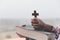 Hands of a Christian woman holding a bible and cross while praying to God