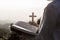 Hands of a Christian Women holding a bible and cross while praying to God, Religious beliefs, Copy space