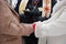 Hands clasped at outdoor winter wedding ceremony