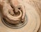 Hands in clay at process of making ceramic on pottery wheel