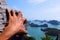 Hands climbing the rock at the viewpoint Angthong island