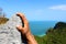 Hands climbing the rock at the viewpoint Angthong island