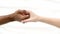 Hands close up multiracial couple african man and caucasian woman romantically touch each other handshake on white