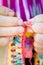 Hands close-up of an old lady knitting on knitting needles, using colorful wool