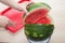 Hands close up of young woman with watermelon cutting watermelon fruit, summer food concept