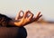 Hands closeup, yoga and beach with woman, lotus and peace of mind in summer sunshine on sand. Girl, zen meditation and