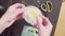 Hands of a confectioner pouring lemon curd into plastic bag