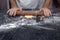 Hands of confectioner preparing dough for sweet pie