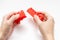 Hands constructing from colorful toy plastic bricks, blocks for building on white background