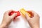 Hands constructing from colorful toy plastic bricks, blocks for building on white background