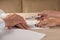 Hands of contractual parties, a woman and a man, signing a contract