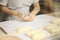 Hands of the cook gently knead dough. Little family bakery