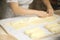 Hands of the cook gently knead dough. Little family bakery