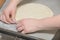 Hands of cook place rolled dough on mold for making dumplings. Cooking process of homemade ravioli