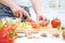 Hands cooking vegetables salad